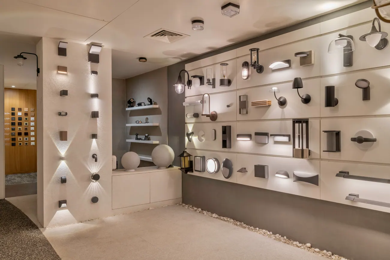 A wall of lighting fixtures on display at Aurora Lights, showing the range to specify from